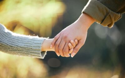 Close up of mother and child holding hands