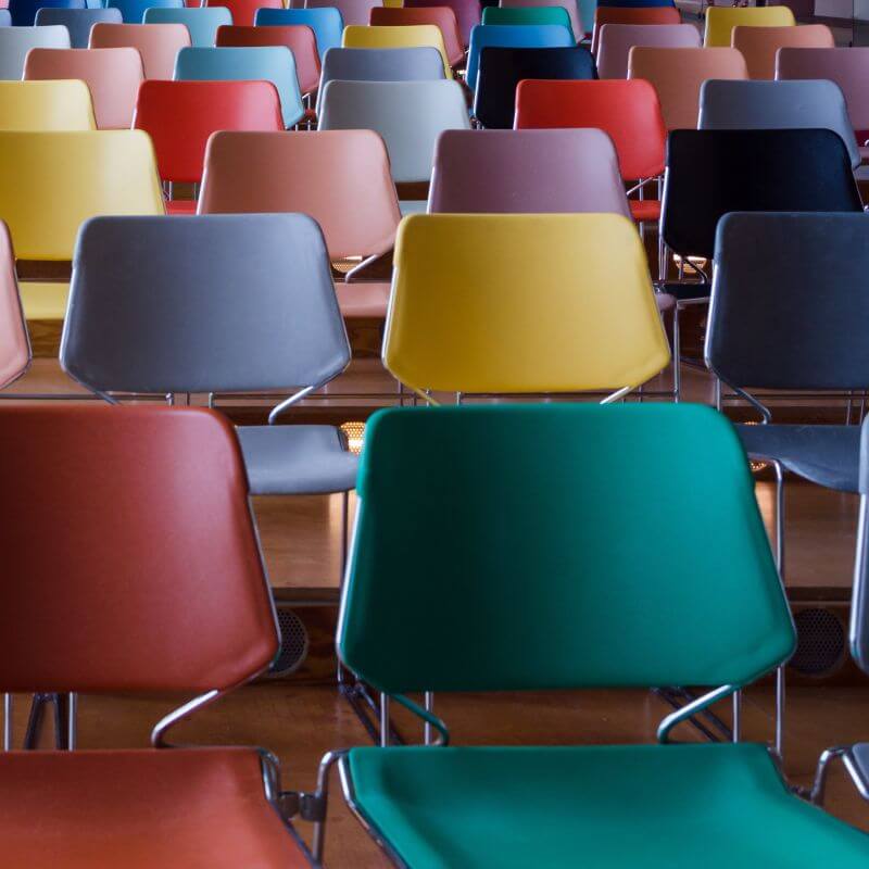 seats Rows of colourful empty seats, depicting spaces available at KFJB Conference 2025